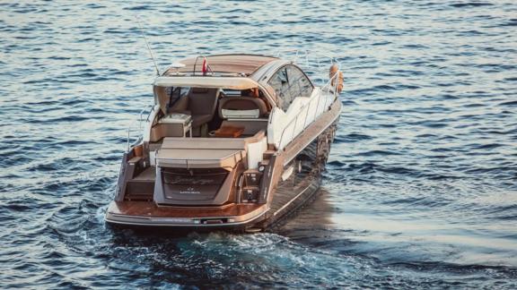 The motor yacht Brown Sugar showcases a modern and elegant design in Croatian waters, viewed from the rear.