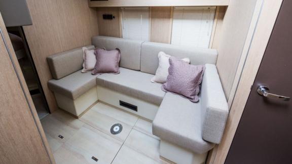 The cozy seating area of motor yacht Brown Sugar is decorated with soft cushions.