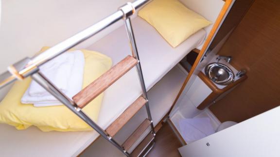 The guest cabin on Whyknot yacht features bunk beds and a sink.