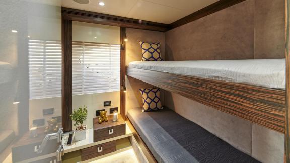 Cozy cabin with modern bunk beds and elegant decor on motor yacht La Fenice.