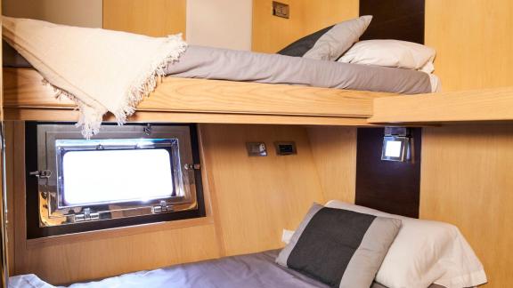 The cabin with bunk beds on motor yacht Chilli offers stylish and modern design with comfort.