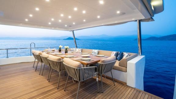 By CF’s aft dining area set against a calm sunset backdrop near Fethiye waters.