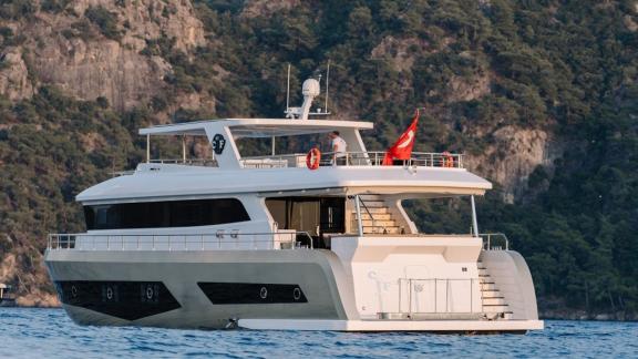 One of the top Fethiye yacht charter options, By CF sits peacefully in a scenic bay.