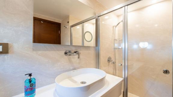 A stylish bathroom with a glass shower, part of Fethiye yacht rental experience.