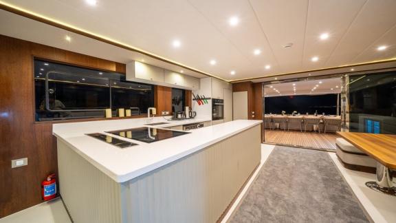Spacious saloon and fully equipped kitchen aboard the modern By CF trawler yacht.