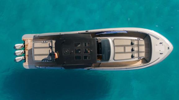 Vibe is anchored in Ibiza, showcasing spacious sunbathing areas for private yacht excursions.
