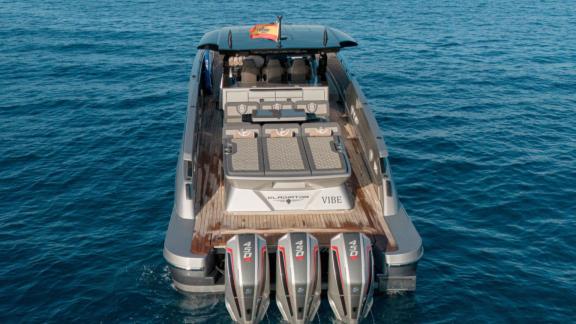 Anchored in Ibiza, Vibe is seen with an aft sunbathing area and triple outboard engines.