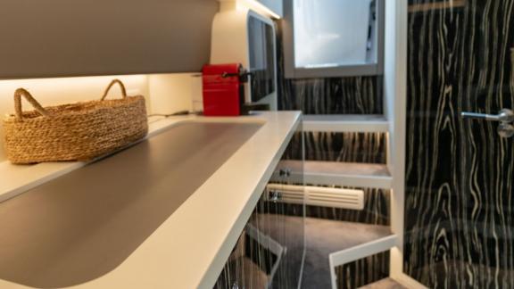 The modern interior of Vibe in Ibiza features storage units and a passageway between onboard areas.