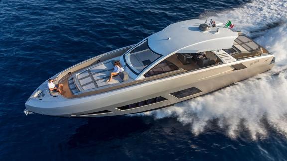 The silver-hulled Next yacht speeds through turquoise waters offering a smooth ride.