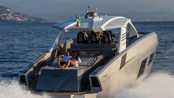 A couple sunbathes aboard the luxury yacht cruising near Mallorca in full comfort.