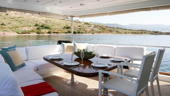 Stylish outdoor dining area with sea view on a yacht in Bodrum, perfect for alfresco dining.