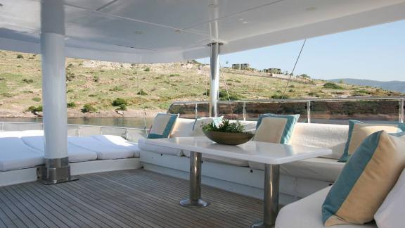 Stylish lounge area with comfortable seating and tables on a yacht in Bodrum.