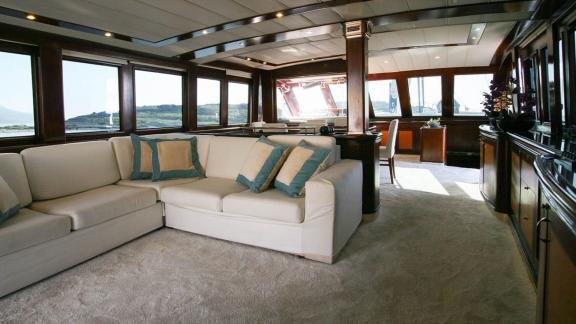 Comfortable living area with large windows and stunning sea views on a yacht in Bodrum.