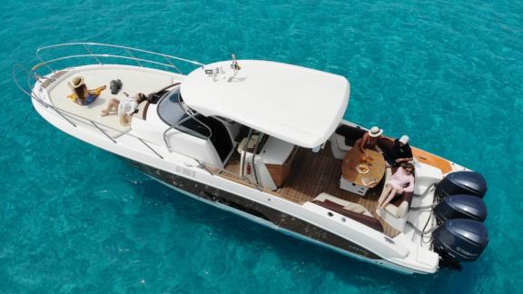 Guests relaxing in the seating and sunbathing area of the motor yacht Carmencita la Grande.