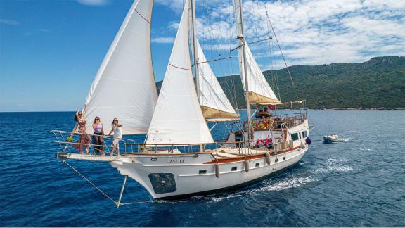 The 22 meter Gulet Castiel sailing with happy guests along the coast of Bodrum.