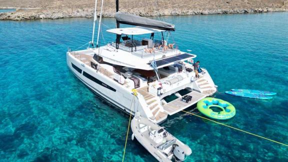 The aft deck of the 7th Heaven catamaran in Athens offers easy sea access and fun water toys.