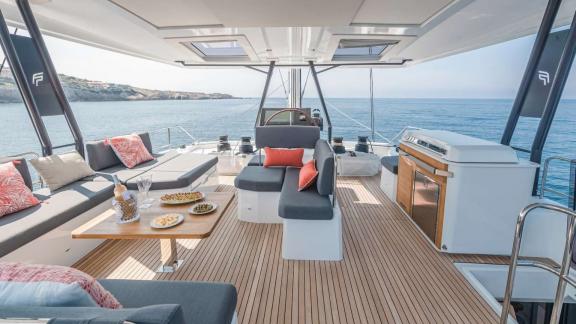 Comfortable relaxation with a sea view on the flybridge of the 7th Heaven catamaran in Athens.