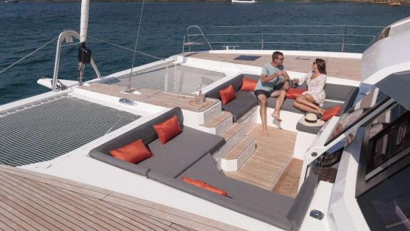 Relax on the comfortable foredeck of the 7th Heaven catamaran in Athens with stunning sea views.