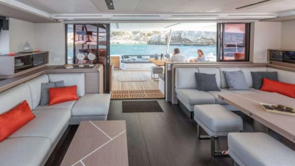 Spacious and comfortable interior lounge with sea view on the 7th Heaven catamaran in Athens.