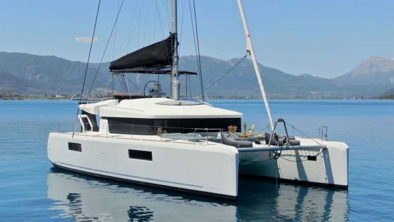 Ace of Hearts catamaran in Athens is anchored on calm water, with the foredeck and flybridge visible.