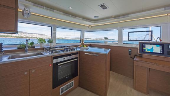 The galley of Ace of Hearts in Athens features a stove, oven, sink and wide windows with sea view.