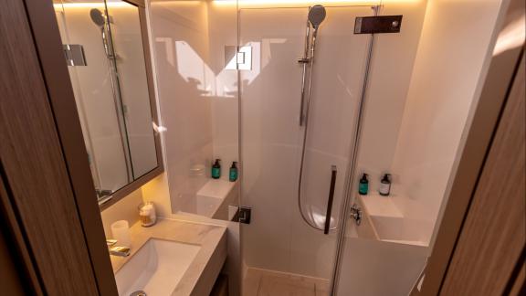 Agenda 55 catamaran features a stylish bathroom with a glass shower cabin and modern illuminated interiors.