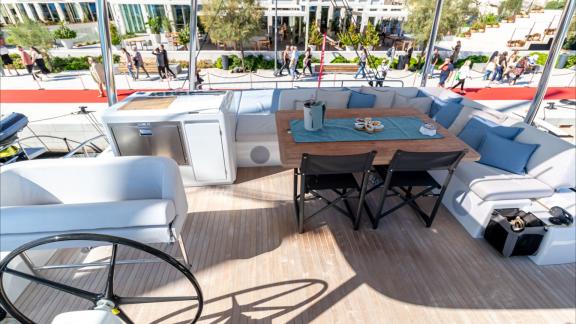 Agenda 55 catamaran features a spacious flybridge lounge and outdoor dining area overlooking the marina.