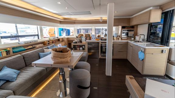 Agenda 55 catamaran features a spacious salon with lounge seating and a modern open kitchen onboard.