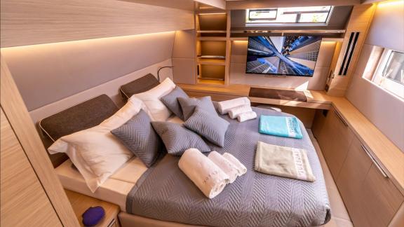 Agenda 55 catamaran features a spacious master cabin with a TV unit and comfortable double bed onboard.