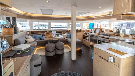 Agenda 55 catamaran features a spacious salon with lounge seating and an open kitchen layout onboard.