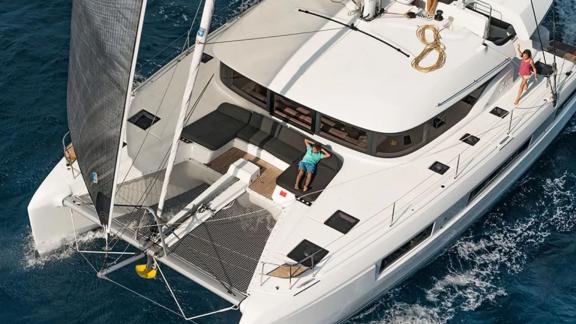 Catamaran Alchera cruising, a child sunbathing.