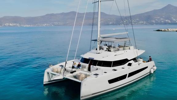 Allure Catamaran anchored in turquoise waters of Athens
