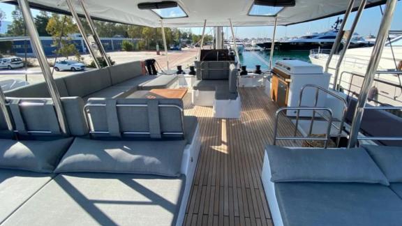 Allure catamaran for rent features a wide upper deck ready for guests at the marina.