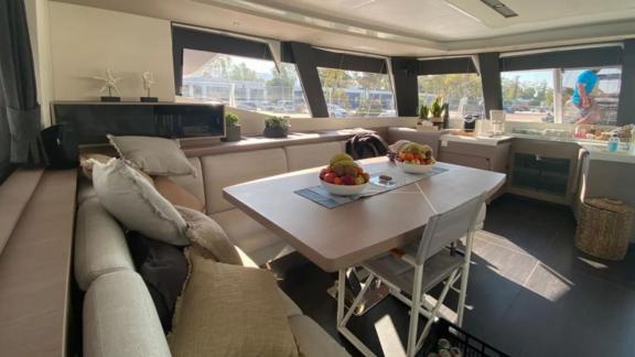 Allure catamaran for rent features a spacious interior saloon with soft seating.