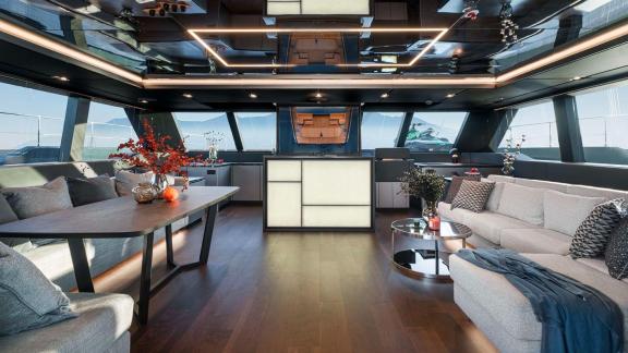 Elegant salon on the Catamaran Alteya with stylish furnishings, spacious sofas, and panoramic windows.