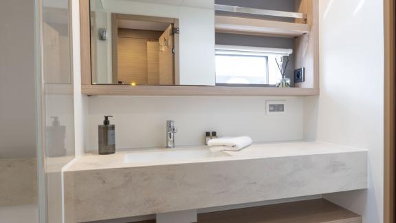 Yacht Artisan offers a stylish and spacious bathroom with refined details aboard Lagoon 55.