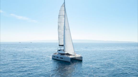 The Artisan catamaran glides through open waters, offering a luxury sailing charter from Split.