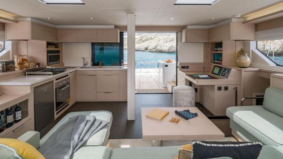 Open salon with fully equipped kitchen and sea view, perfect for comfortable living on board.