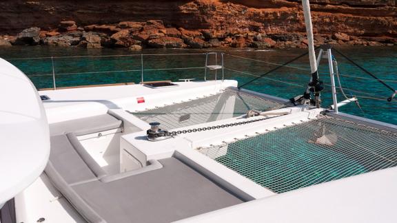 Enjoy the sun on the spacious net deck of the Balok catamaran in Ibiza.