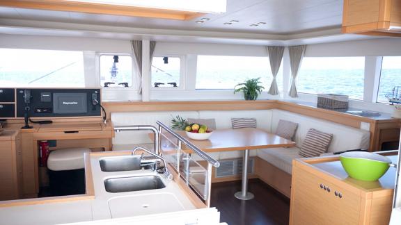 The spacious salon of the Balok catamaran features a cozy seating area and a modern kitchen.