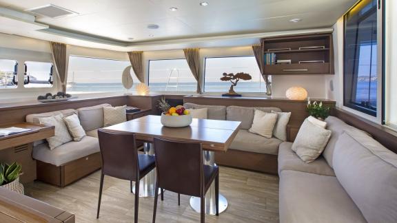 The stylishly furnished salon of the Lagoon 560 in Athens offers comfortable seating and expansive views of the sea.