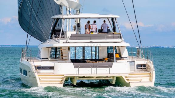 The Catamaran Daiquiri sailing at full speed as guests enjoy the view from the flybridge off the coast of Athens, Greece