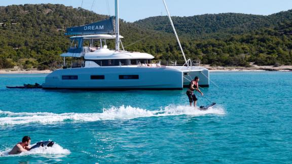 Guests enjoy jetboarding near the Dream catamaran on calm Athenian waters.