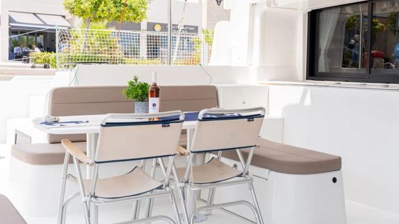 Among Rhodes catamaran charter options Escape 46 shows cockpit with table and comfortable seating area.