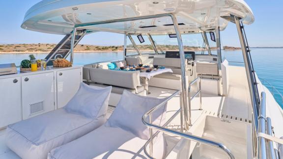 Überdachte Lounge und Sonnenliegen sorgen für entspannte Momente an Deck.