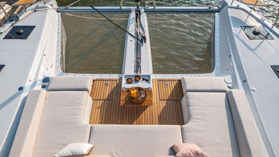 The catamaran Happy offers a cushioned seating area on the deck, perfect for sunbathing and relaxing.