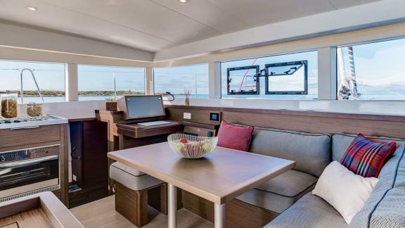 Stylish living area on the Hayra Lagoon 40 catamaran with panoramic views and comfortable furnishings.