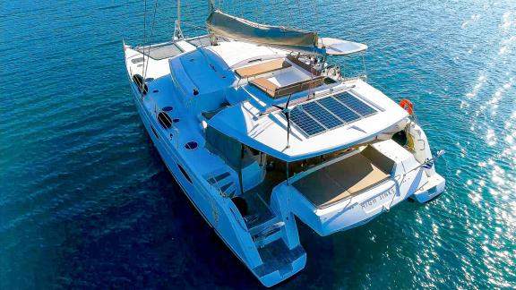 The deck of catamaran High Five is seen from above, featuring spacious seating areas.