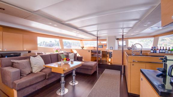 The salon of catamaran High Five features a comfortable seating area and a stylish table.