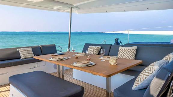 The catamaran Kebisiks features sea-view seating and a set table near Athens.